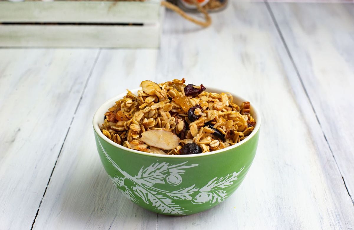 A green holiday bowl filled with Homemade Christmas Granola recipe 
