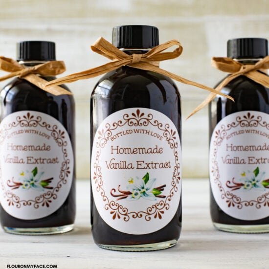 Bottled homemade vanilla extract with printable labels attached.