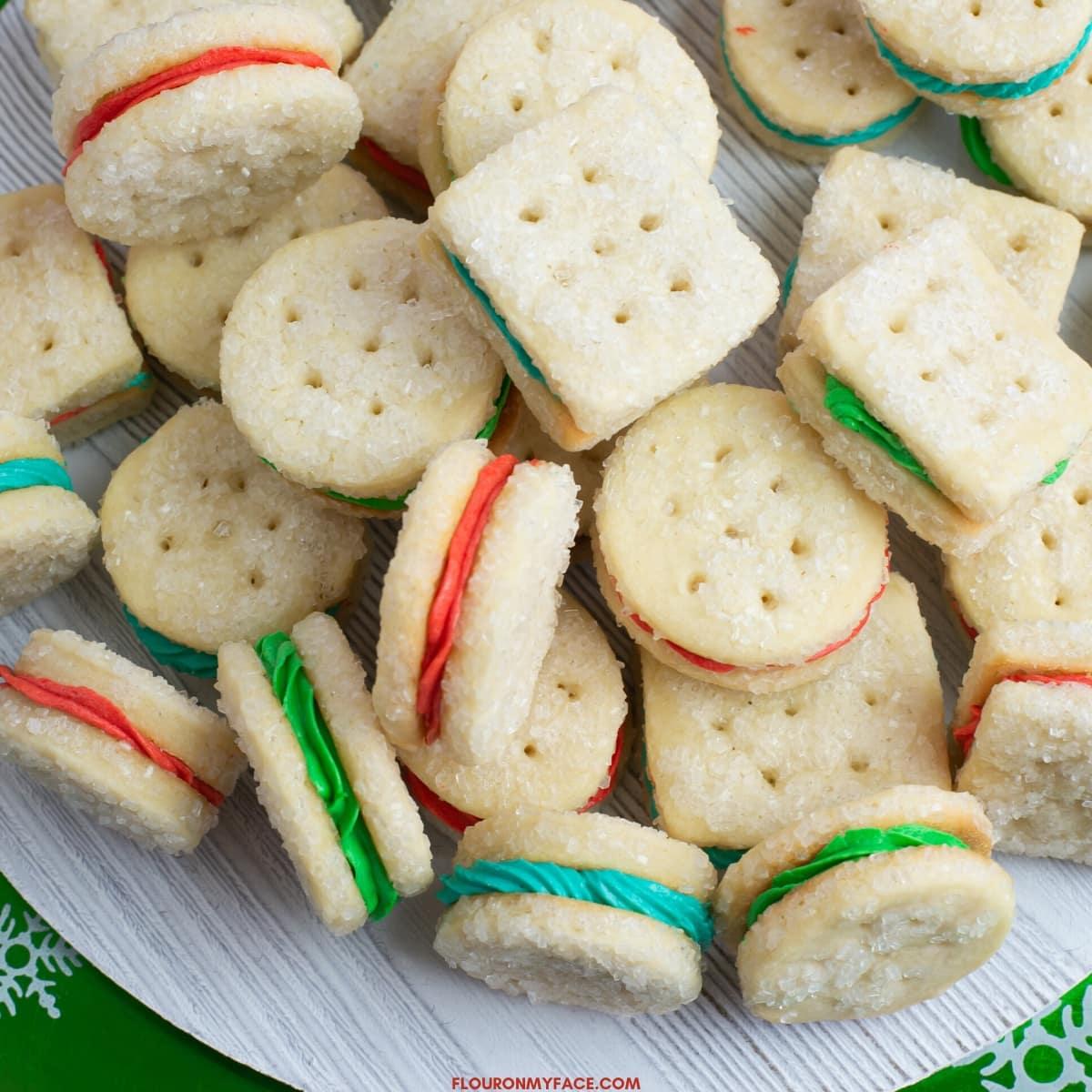 Christmas Sandwich Cookies on a wooden serving plate.