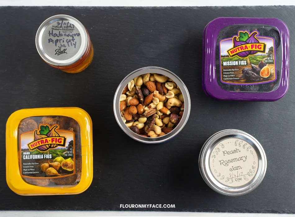 A photo of mixed nuts, dried figs and savory jam for a meat and cheese platter