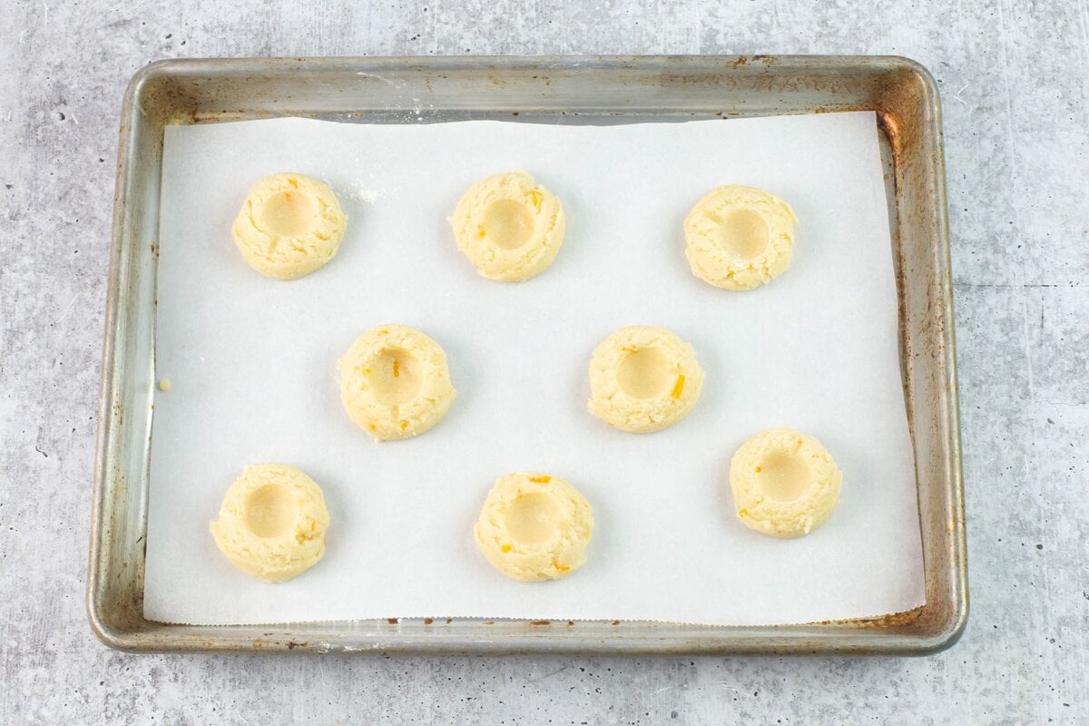 How to make an indention for jam in the center of cookie dough.