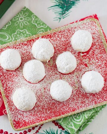 Mexican Wedding Cookies on a red holiday plate.