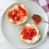 Homemade Carambola Strawberry Jam spread over a toasted bagel with cream cheese