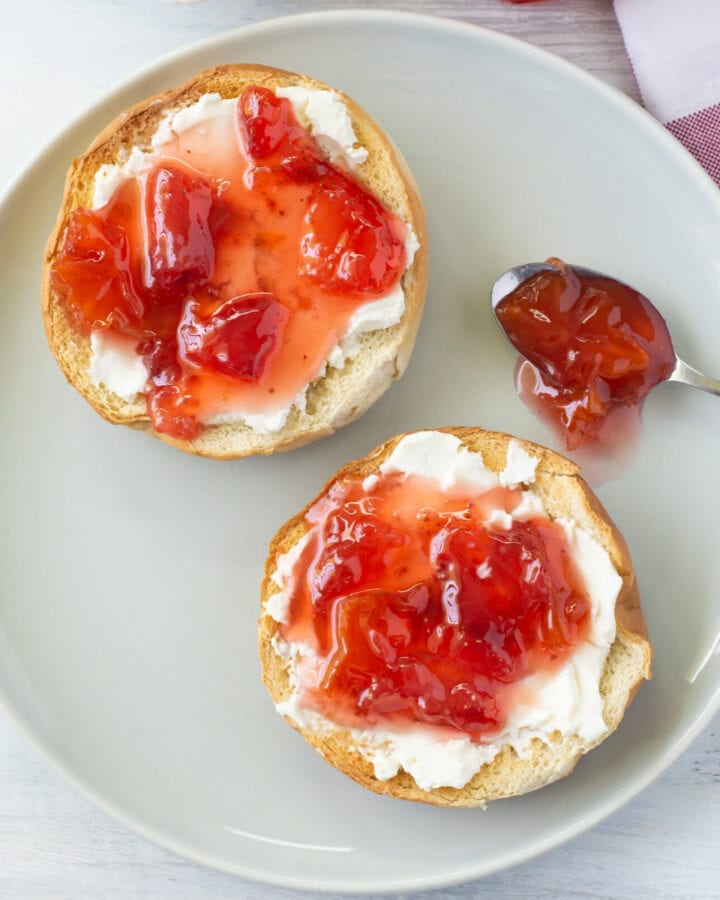 Homemade Carambola Strawberry Jam spread over a toasted bagel with cream cheese