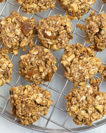 overhead closeup photo of Apple Cinnamon Breakfast Cookies as the cool on a cooling rack