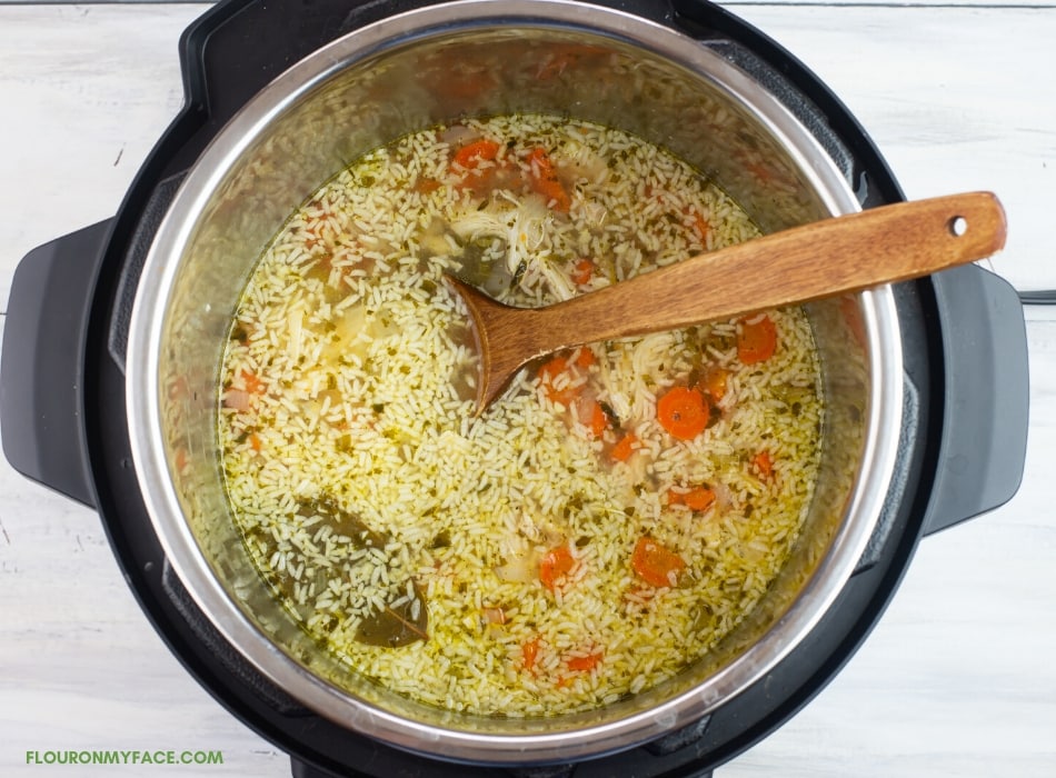 over head of adding rice to Instant pot chicken soup recipe