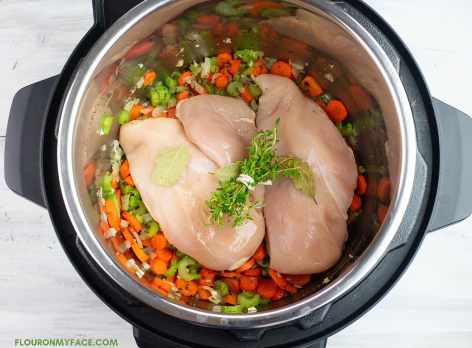 Chicken and Rice Soup Ingredients inside the Instant Pot inner pot before pressure cooking