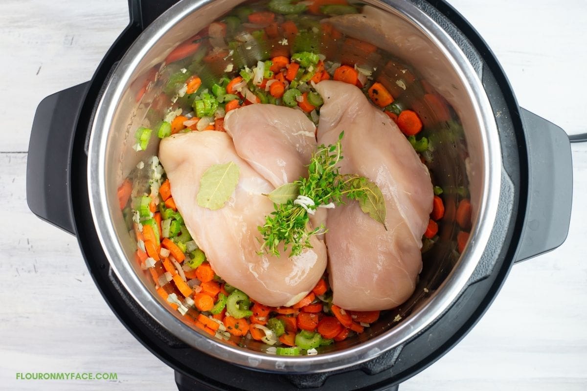 Chicken and a bundle of fresh type added to the pressure cooker.
