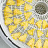 dehydrated pineapple pieces on the tray of a food dehydrator