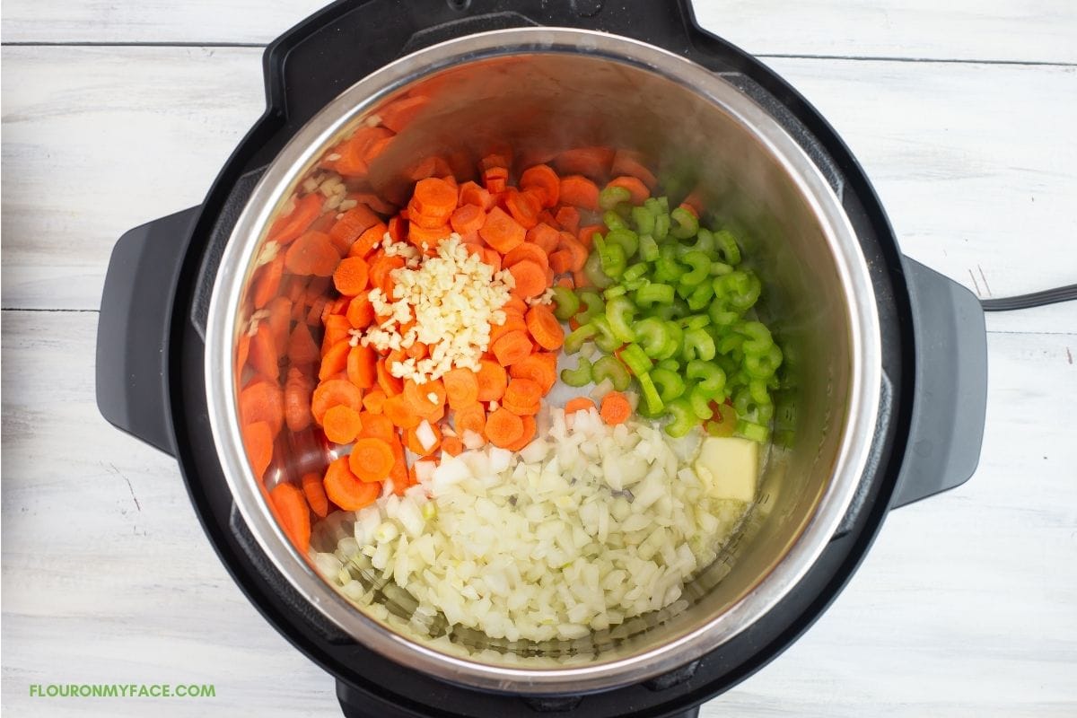 Sautéing vegetables in the instant pot for chicken and rice soup. 