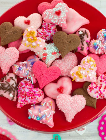 Valentines Day Spritz Cookies overhead photo with the Valentines day treats piled on a red cake stand