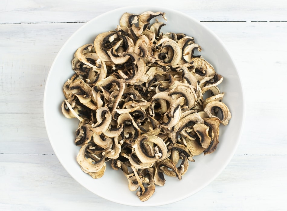 dried bella mushrooms in a white glass bowl