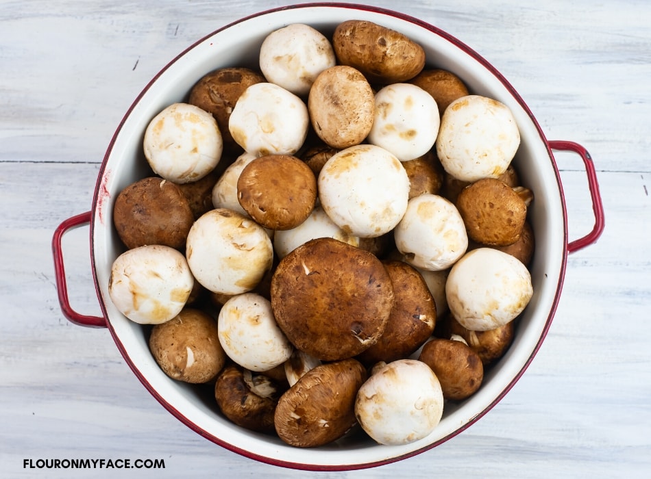 fresh bella mushrooms in a colander