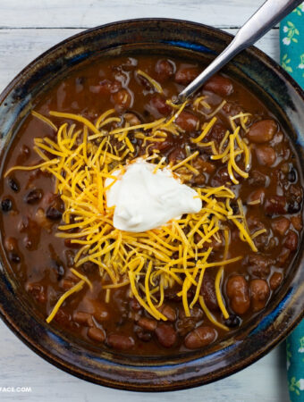 A bowl of Turkey Chili topped with shredded cheese and sour cream