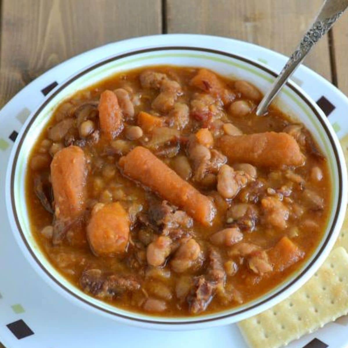 A bowl filled with great northern beans cooked with ham.