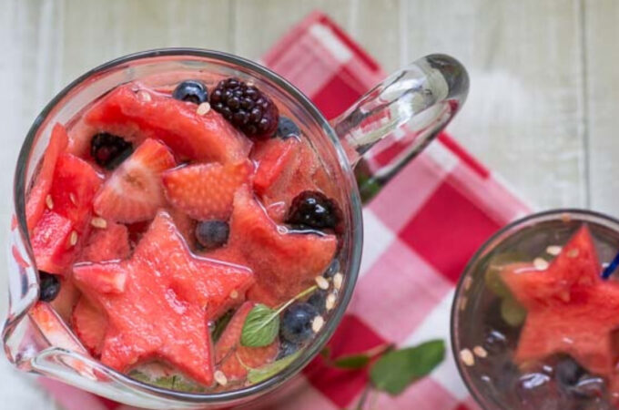overhead photo of a fill glass pitcher of fruity sangria