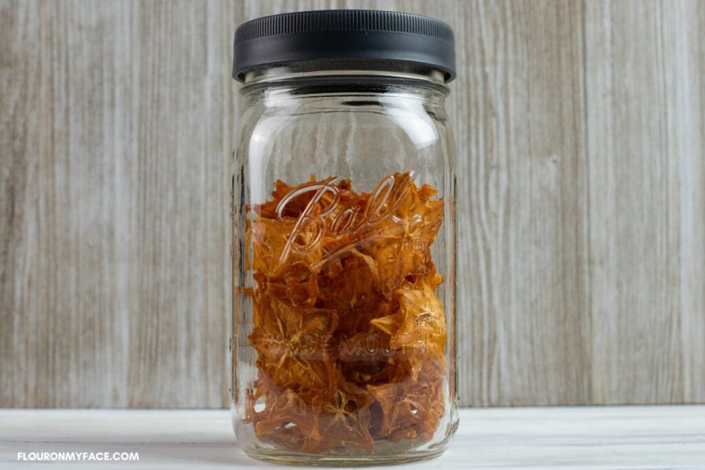 Closeup photo of dried star fruit in a quart size mason jar.