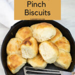 Fluffy biscuits in a cast iron pan.