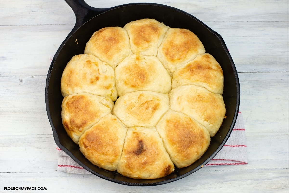Golden brown and fluffy fresh baked biscuits in a baking pan