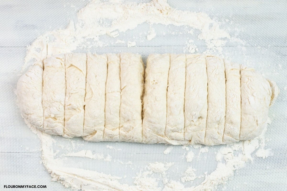 biscuit dough formed into a log and sliced in 1 inch slices