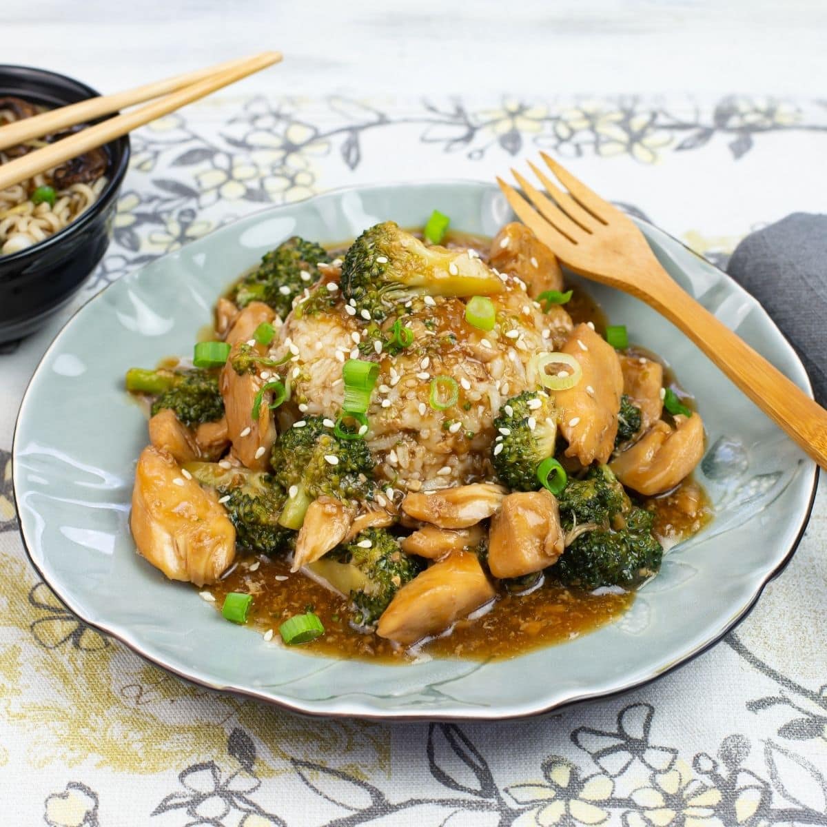 Serving Instant Pot Chicken and Broccoli over a mound of white rice with a bowl of mushroom noodle soup