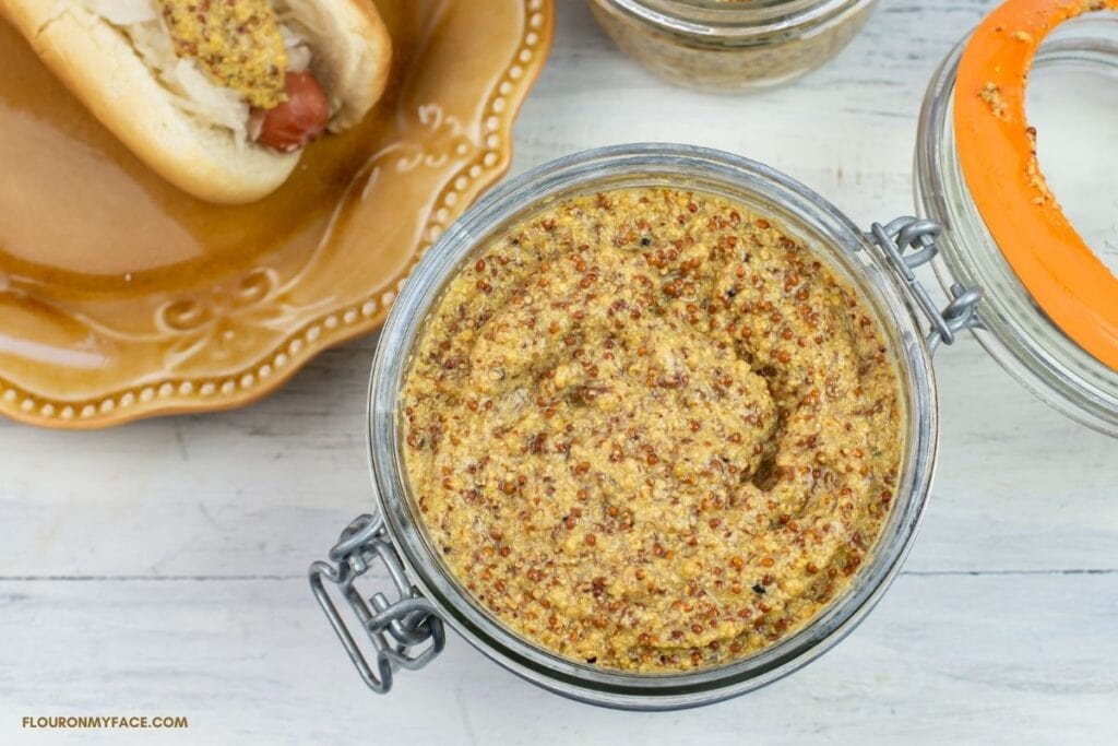 a wide mouth jar filled with whole grain Dijon mustard