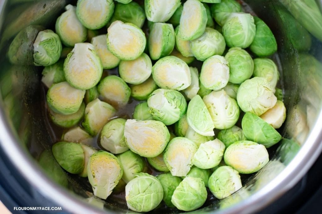Brussel sprouts that have been trimmed and cut in half added to the pot.