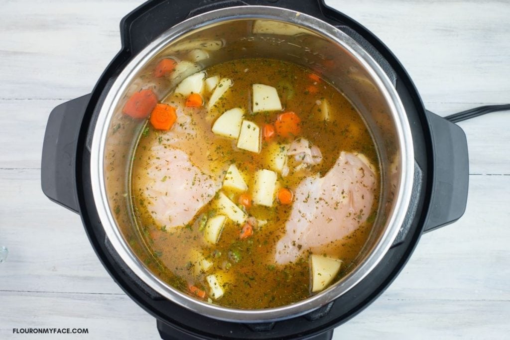 Chicken Stew ingredients in a pressure cooker.