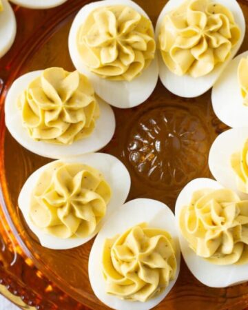 A holiday serving plate with deviled eggs on it.