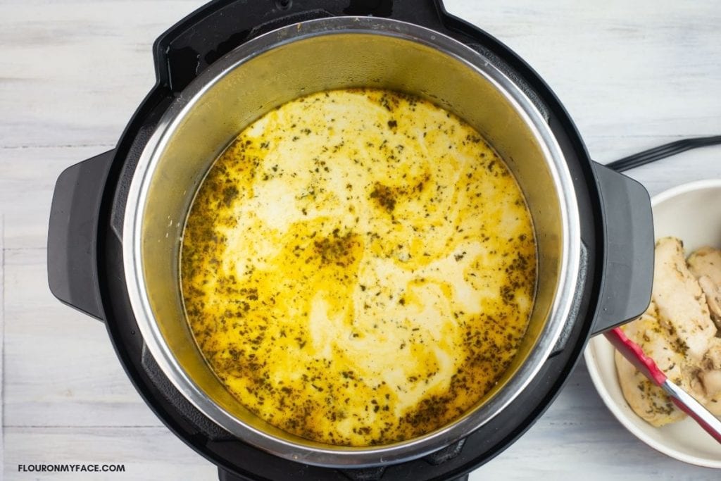 Adding cream and starch slurry to chicken stew.