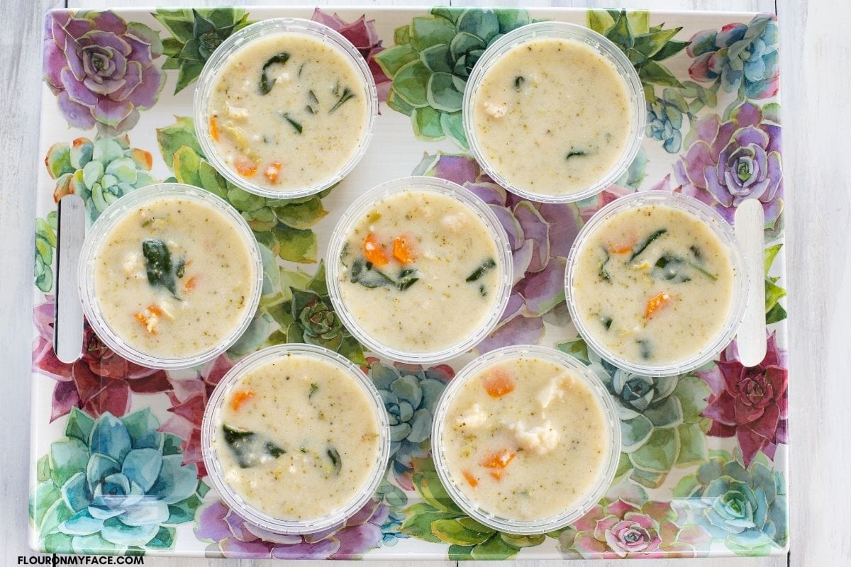 food grade single serve containers filled with soup on a tray