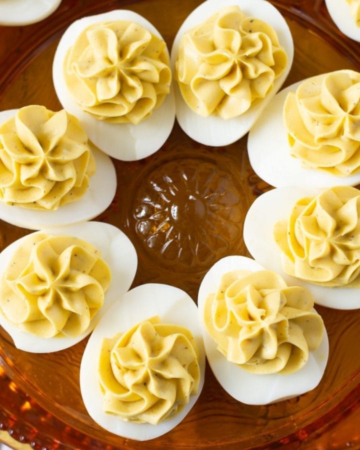 A holiday serving plate with deviled eggs on it.