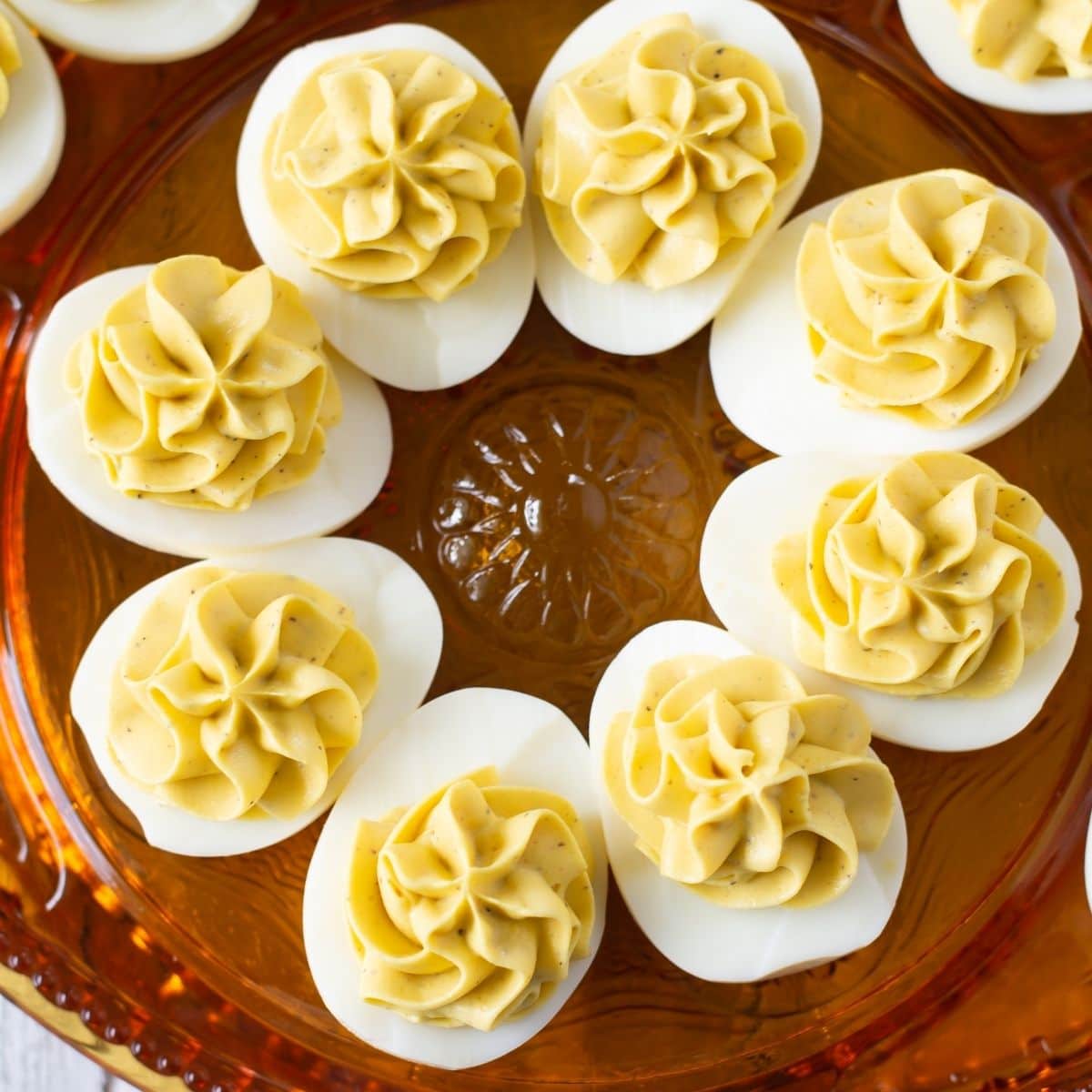 A holiday serving plate with deviled eggs on it.