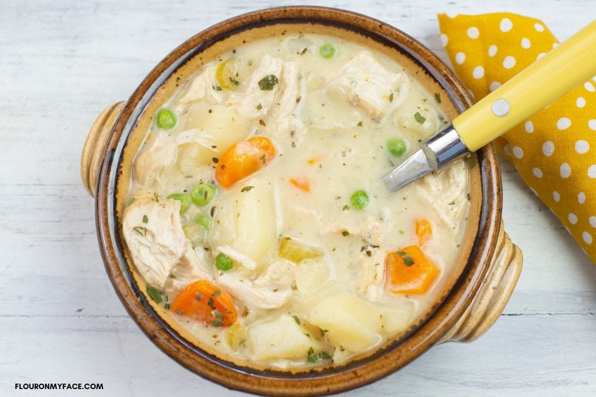 brown bowl filled with chicken stew.