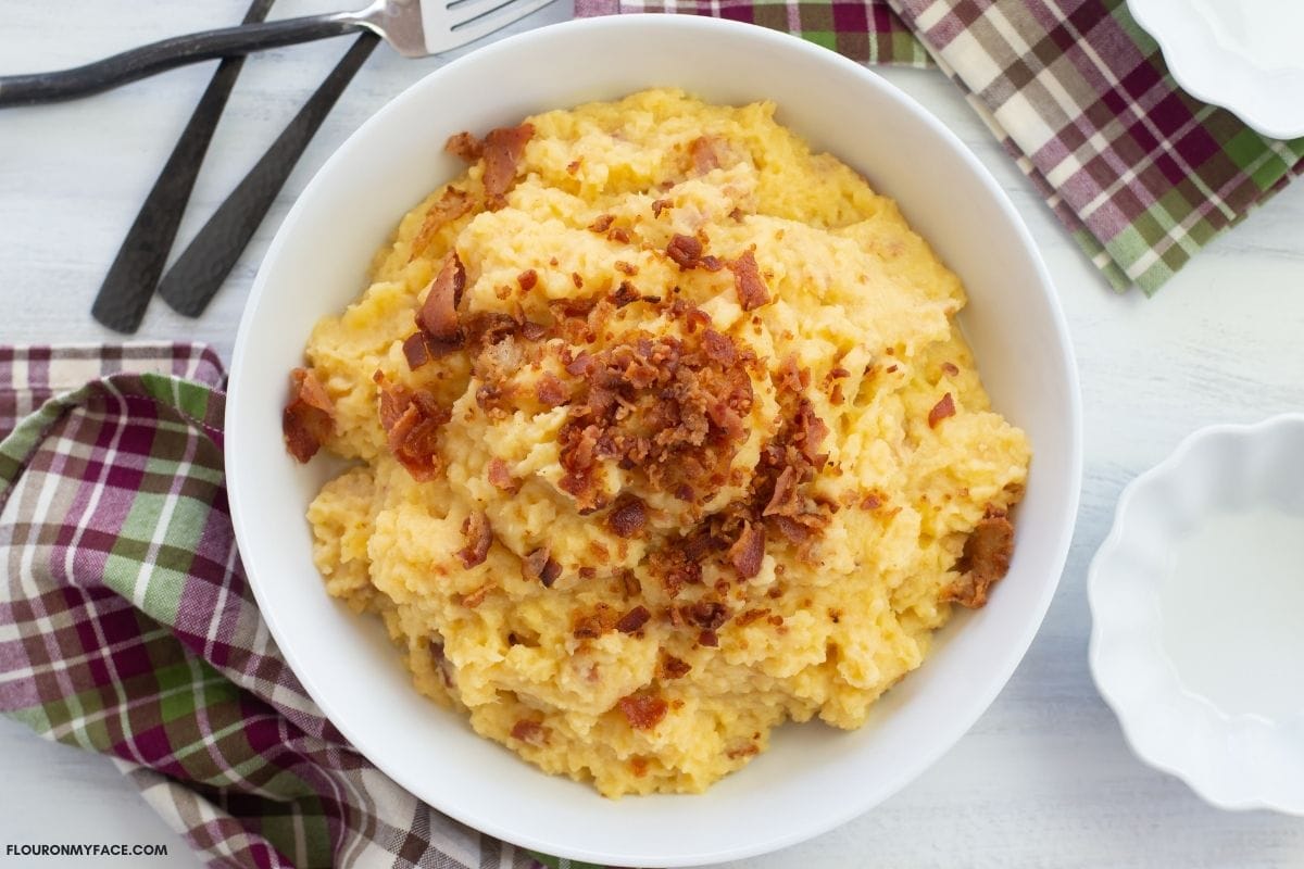 Mashed rutabaga in a white serving bowl.