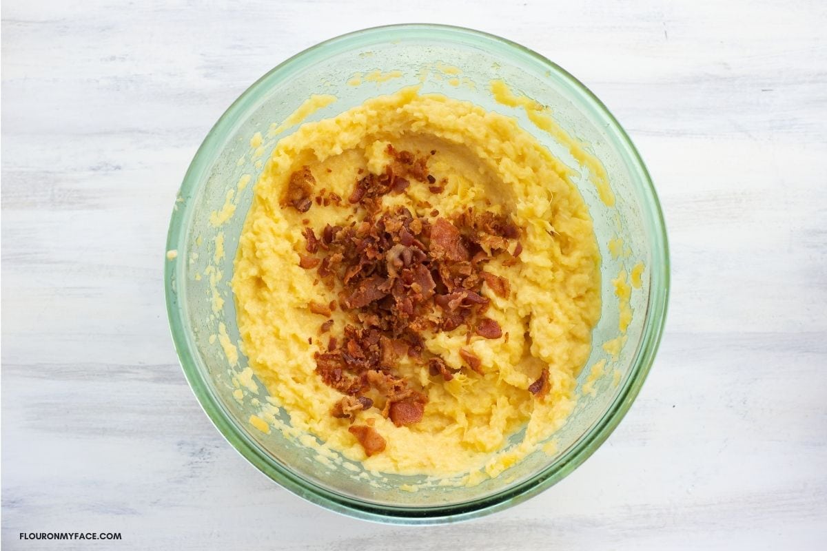 Mashed rutabaga with crumbled bacon on top.
