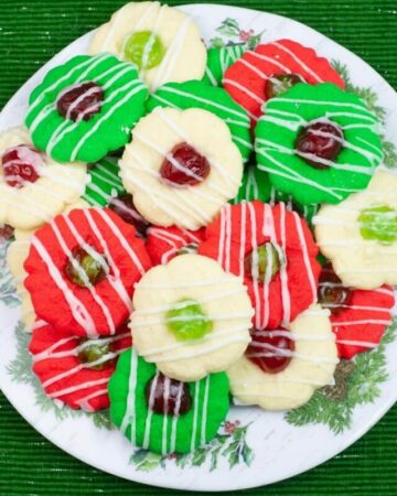 Red, green and white Christmas Spritz cookies on a holiday plate.