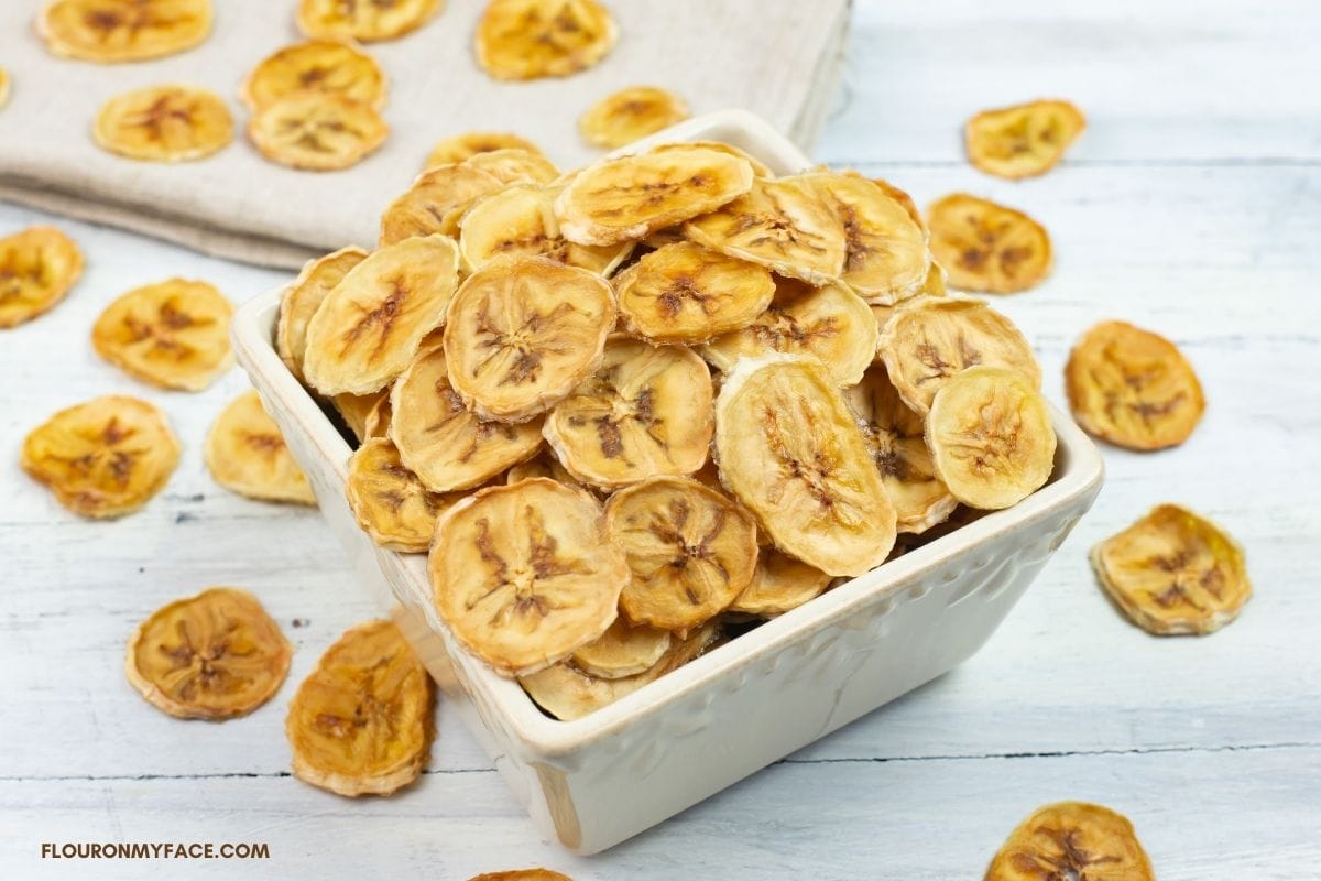Homemade banana chips in a small serving bowl.