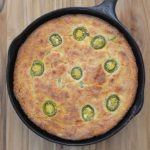 Cast iron skillet filled with golden jalapeno cornbread