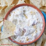 White Queso dip in a dip bowl with chips.