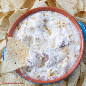 White Queso dip in a dip bowl with chips.