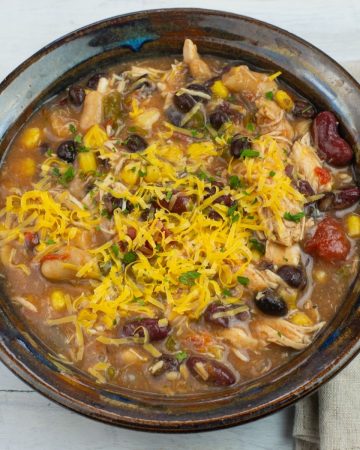 chicken chili topped with cheese in a bowl.