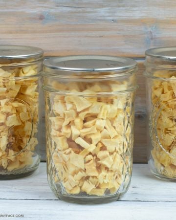 Dehydrated Diced Apple Pieces in small mason jars.