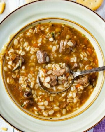 Bowl filled with beef barley soup.