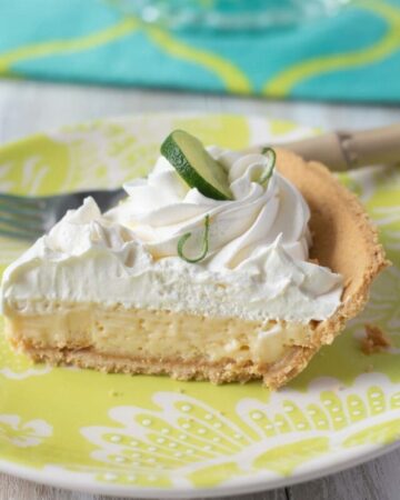 Piece of Key Lime Pie on a glass plate.