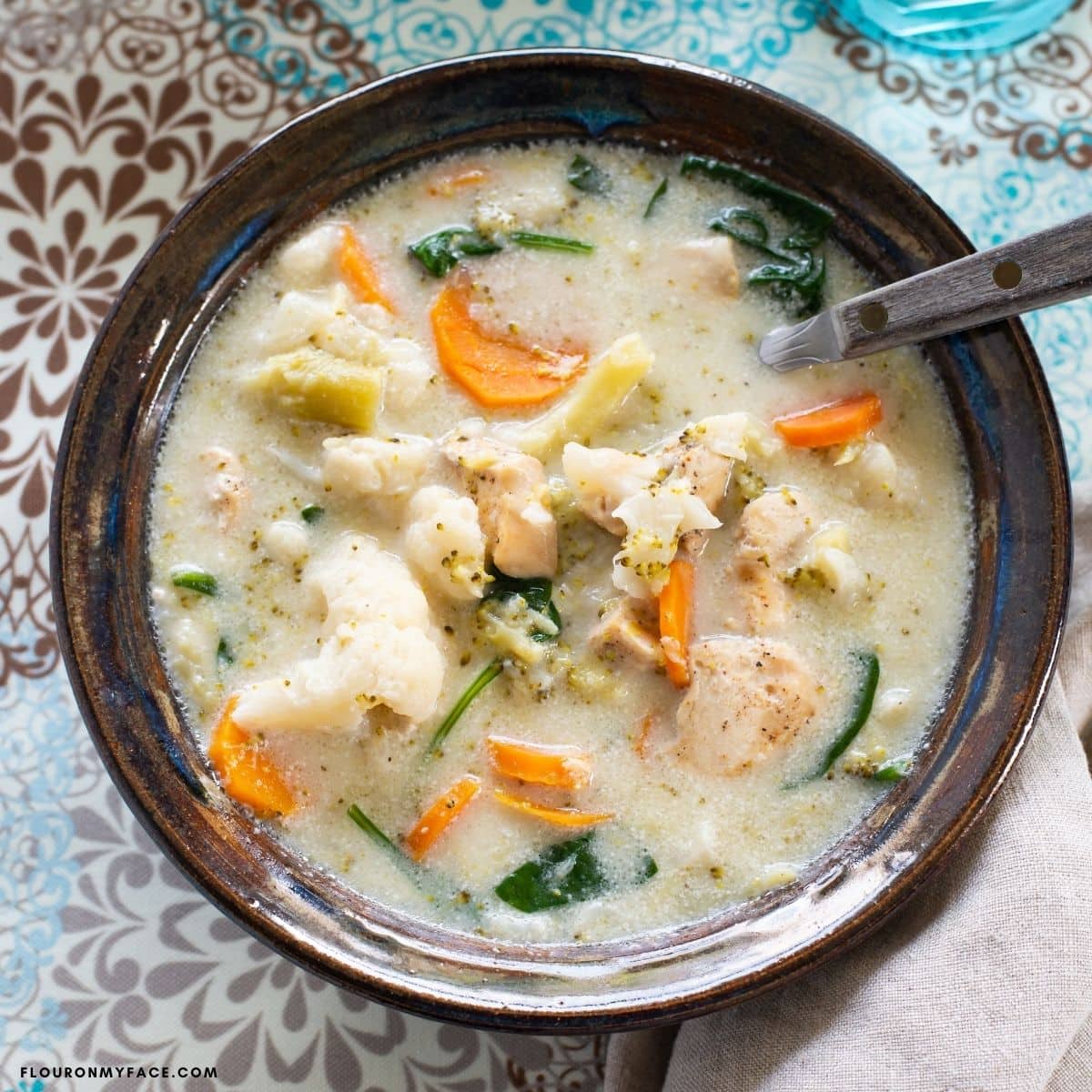 Overhead photo of a bowl filled with creamy chicken soup.