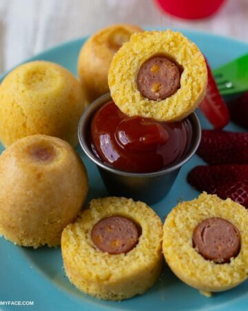 Mini Corn Dog Bites served with ketchup on a blue plate.