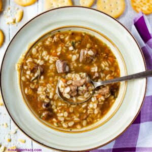 Beef Barley Soup in a bowl with crackers.