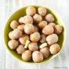 A bowl filled with Salt Potatoes with pats of butter.