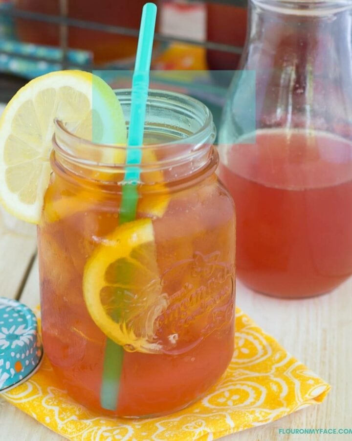 Peach Iced Tea in a mason jar with a straw.